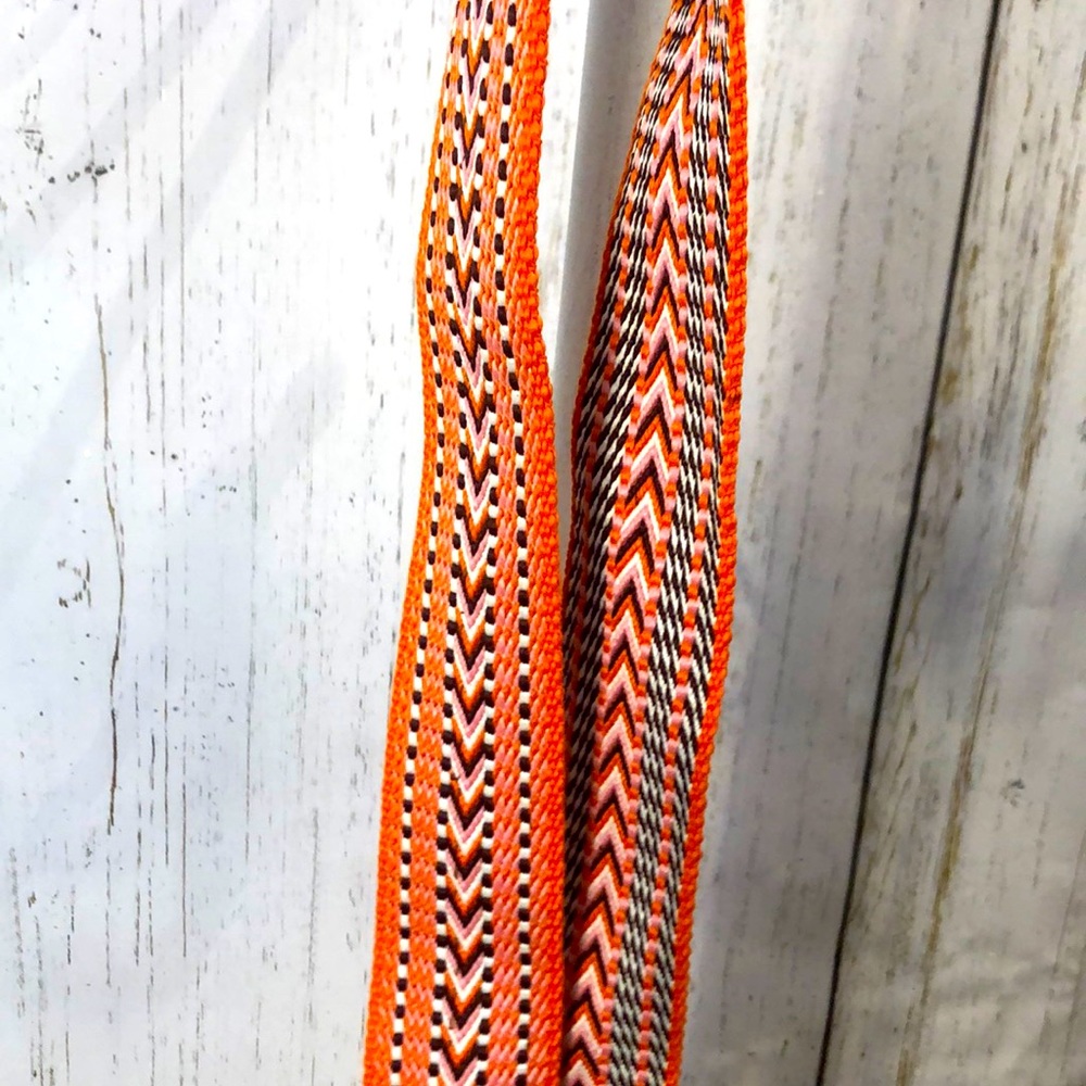 Orange, brown and pink crossbody strap.